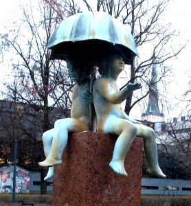 Sculptures of boys with an umbrella