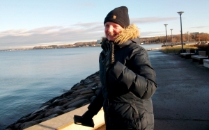 A cheerful girl on the embankment